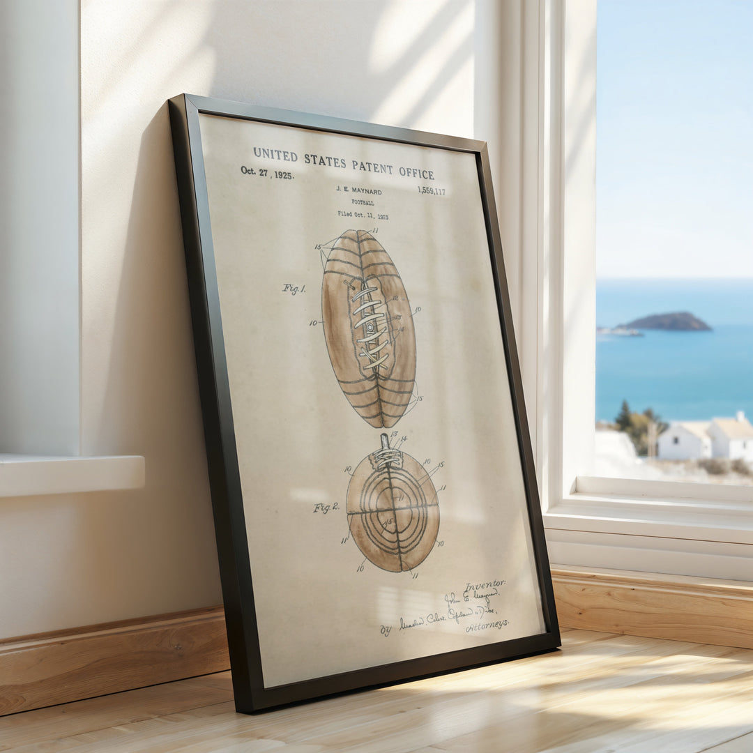 a framed drawing of a football on a window sill