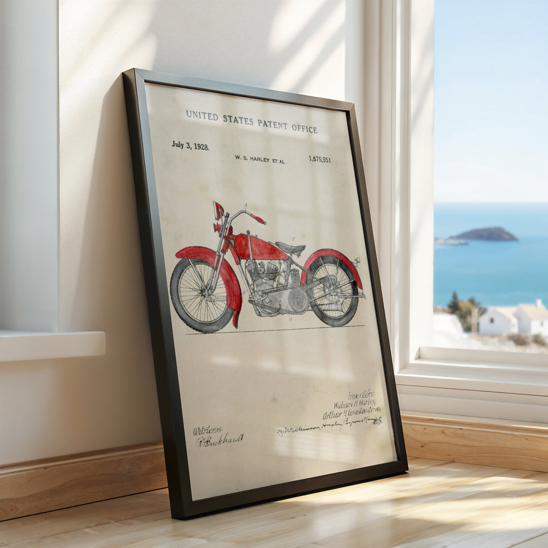 a framed picture of a motorcycle on a window sill