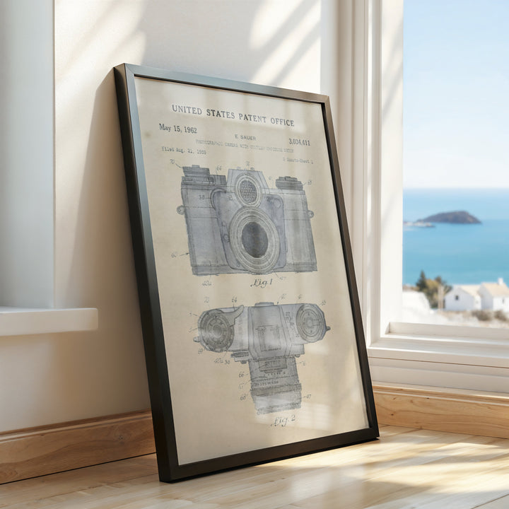 a framed picture of a camera on a window sill