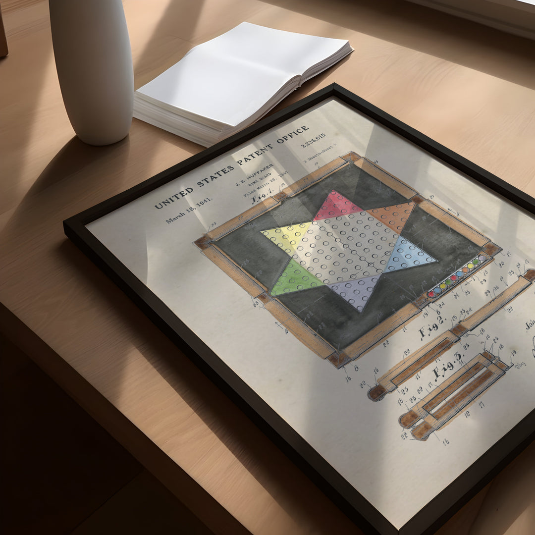 a framed picture of a quilt on a table