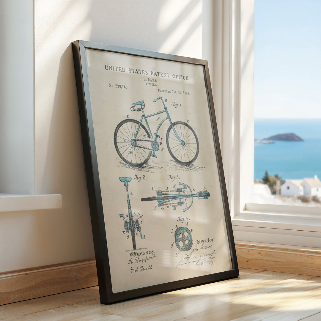 a framed picture of a bicycle on a window sill