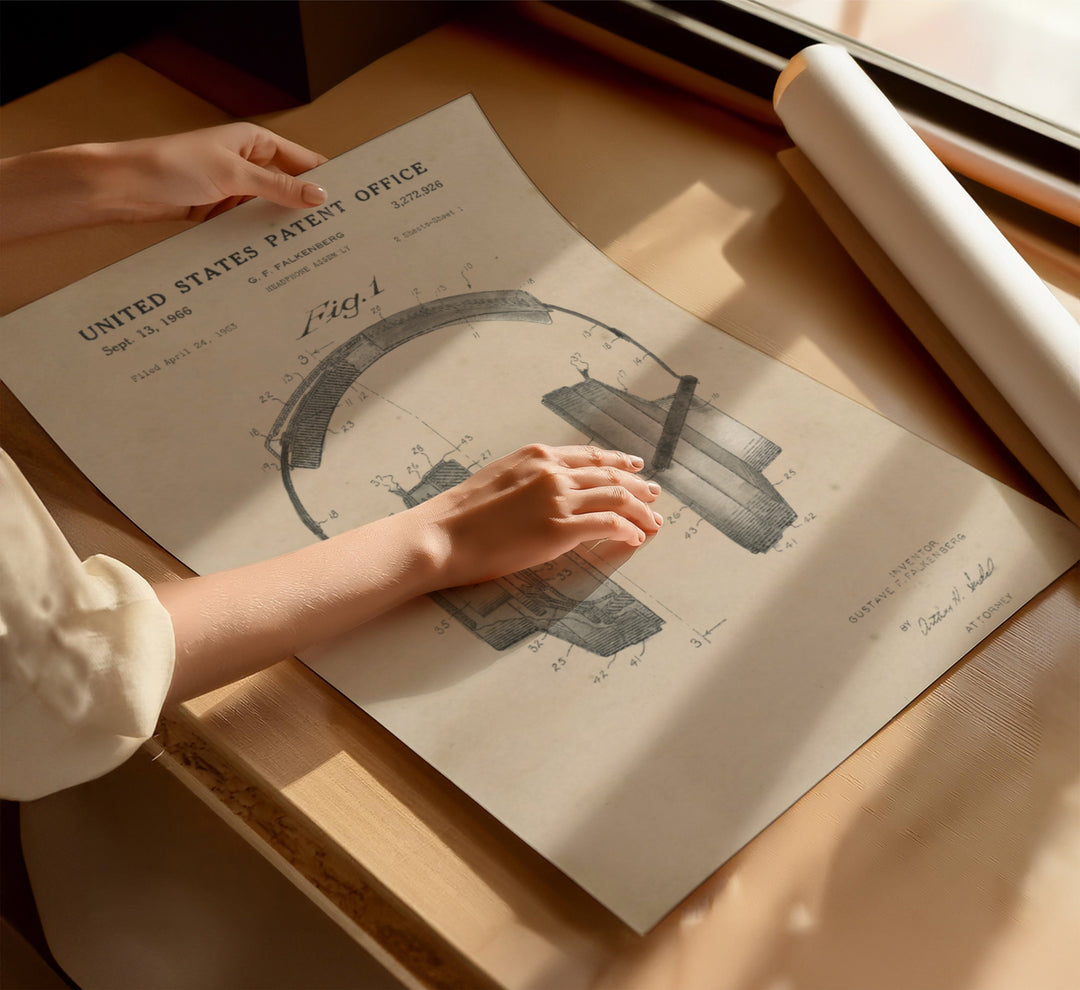 a person holding a piece of paper on top of a table