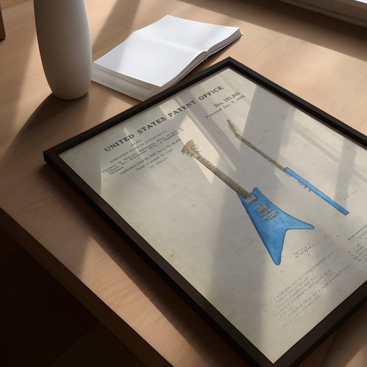 a picture of a blue guitar sitting on top of a table