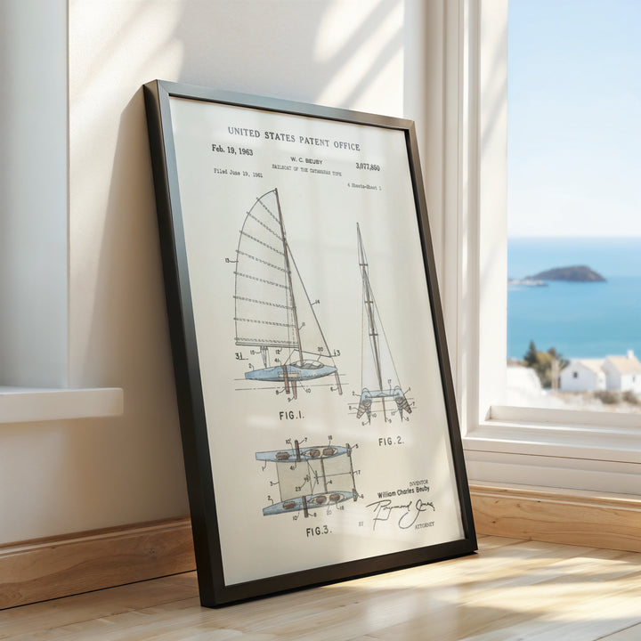 a framed picture of a sailboat on a window sill