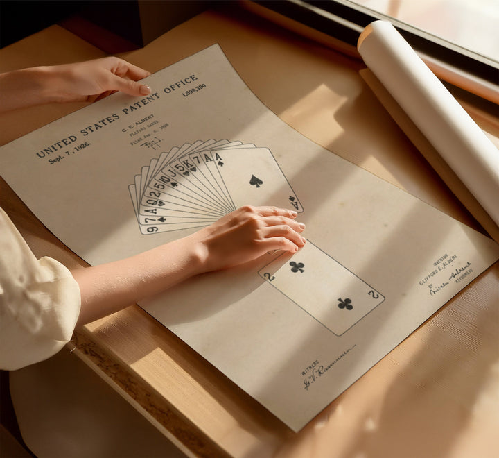 a person's hand holding a card on top of a table