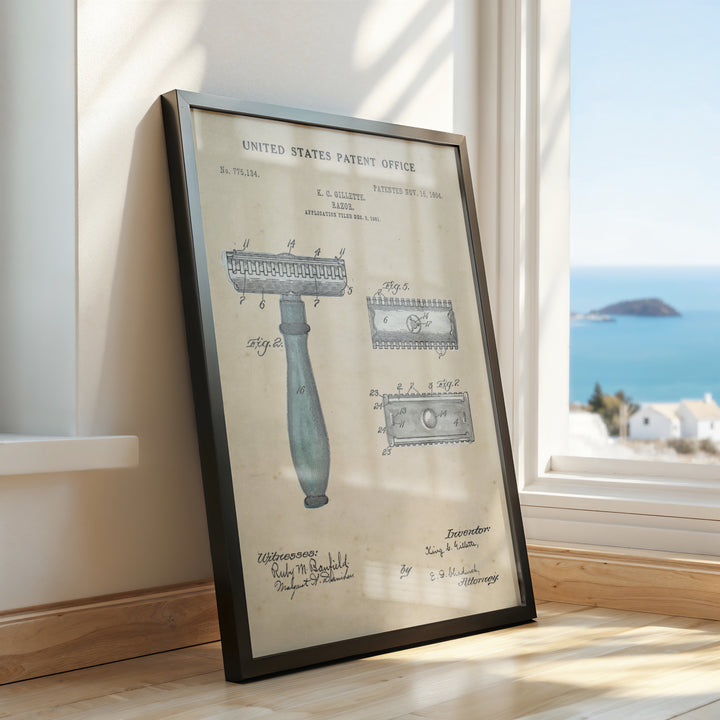 a framed picture of a razor on a window sill