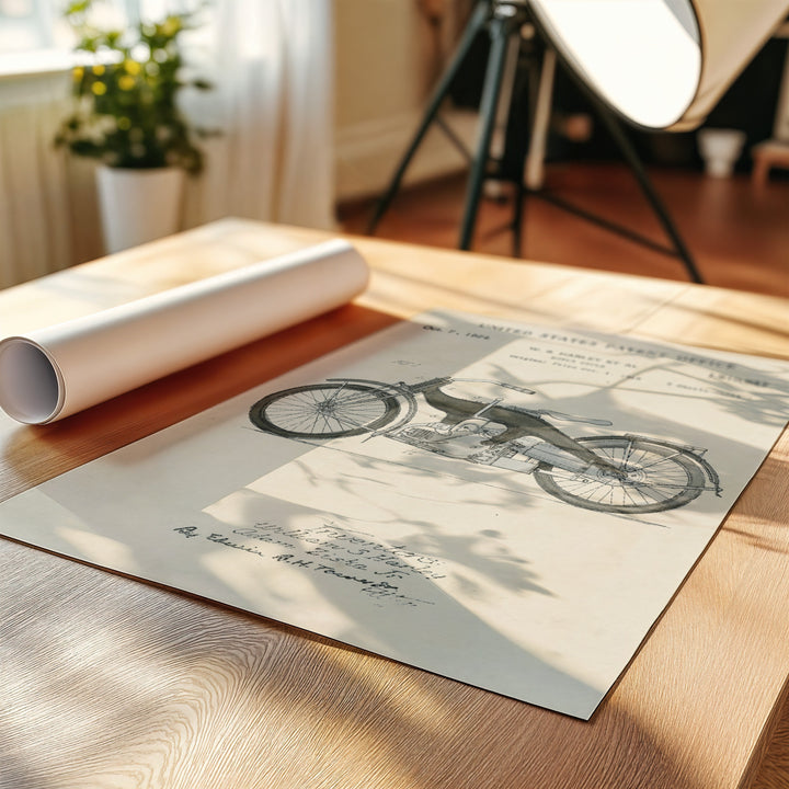 a picture of a bicycle on a table next to a roll of paper