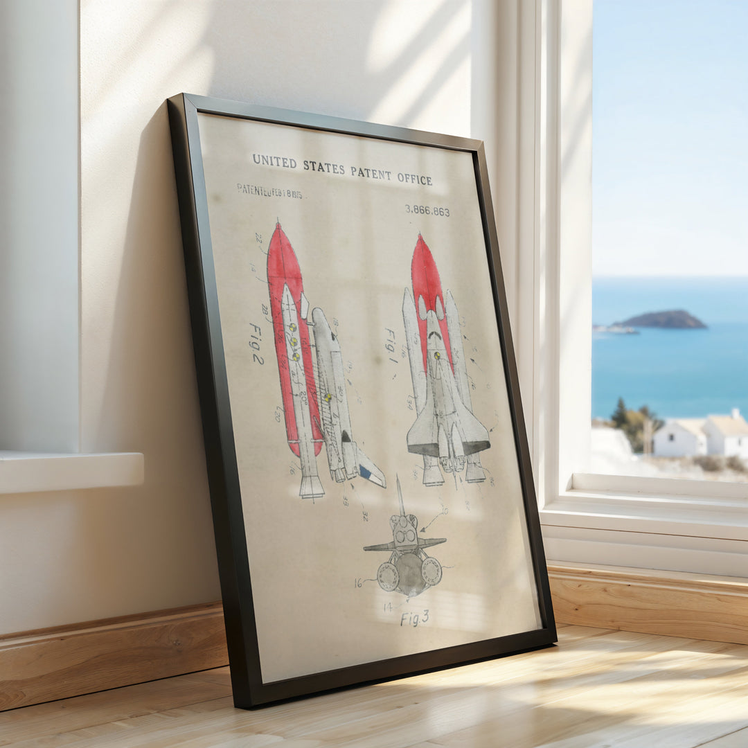 a framed picture of a space shuttle on a window sill