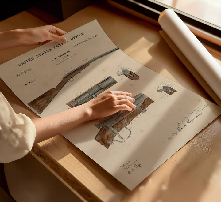 a person holding a paper with a drawing of a gun on it