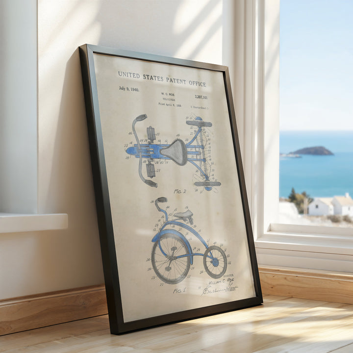 a framed picture of a bicycle on a window sill