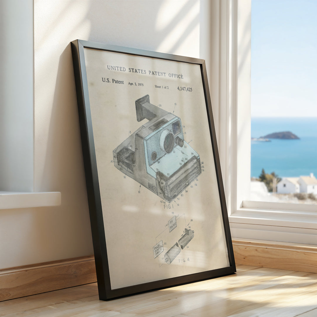 a framed picture of a camera on a window sill