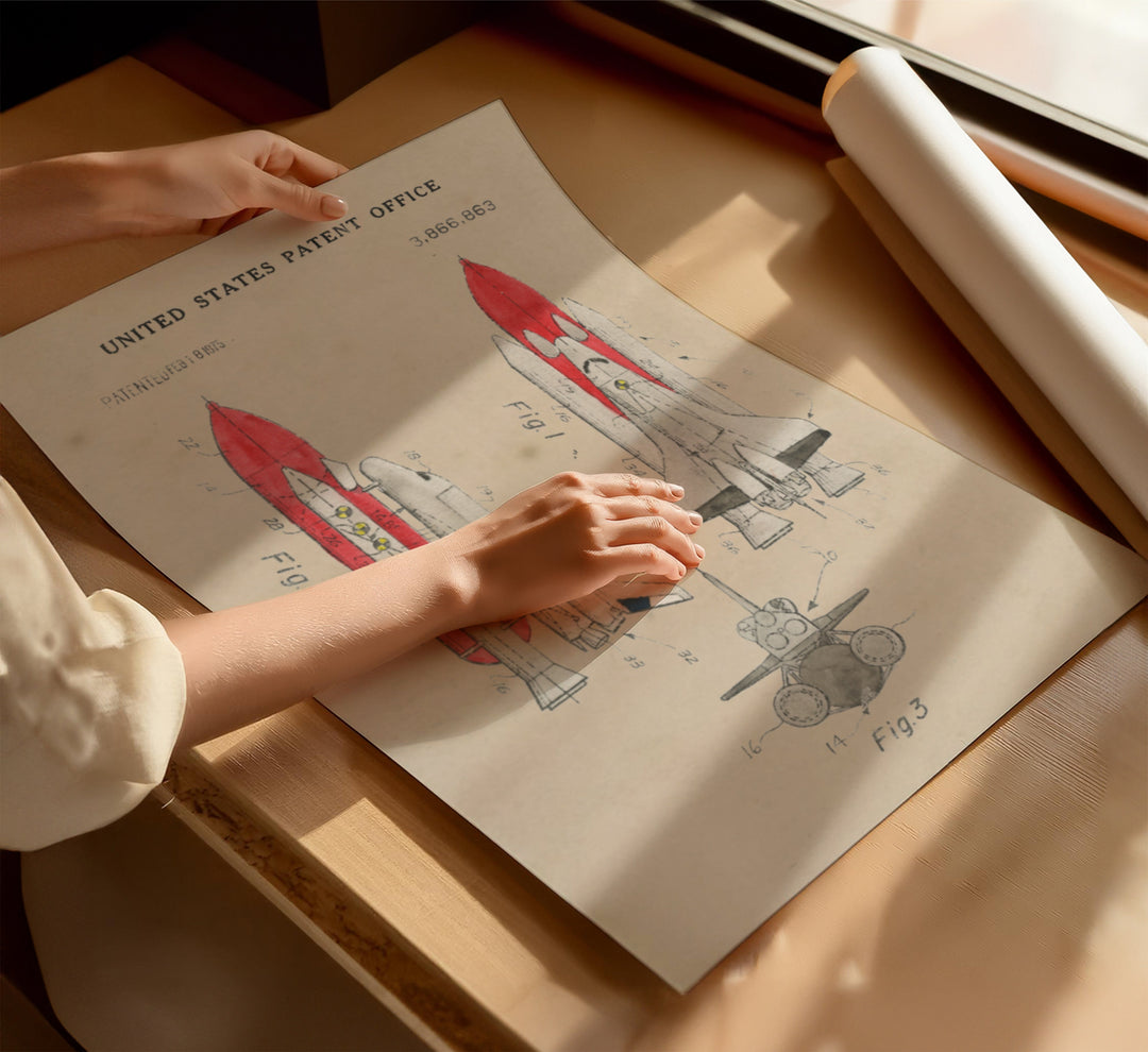 a person holding a piece of paper with a drawing of a rocket on it